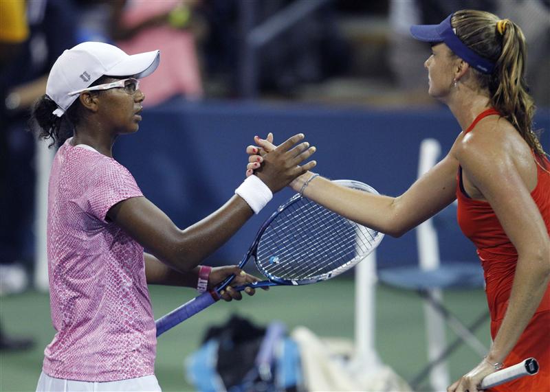 Victoria Duval of the U.S. shakes hands after losing to Daniela Hantuchova of Slovakia at the U.S. Open tennis championships in New York